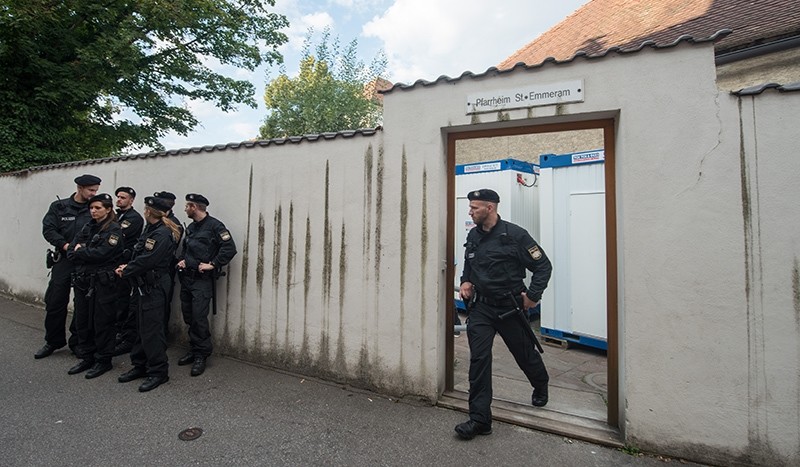 In this Aug. 8, 2016 picture police officers standing in front of the parish hall of St. Emmeram where refugees were living in Regensburg, Germany (AP Photo)