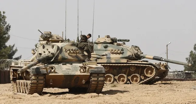 A Turkish soldier on his tank as they prepare for a military operation at the Syrian border as part of their offensive against the Daesh militant group in Syria. (EPA Photo)