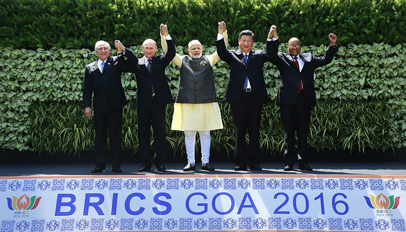 Leaders of BRICS countries raise their hand for a group photo at the start of their summit in Goa, India, Sunday, Oct. 16, 2016 (AP Photo)