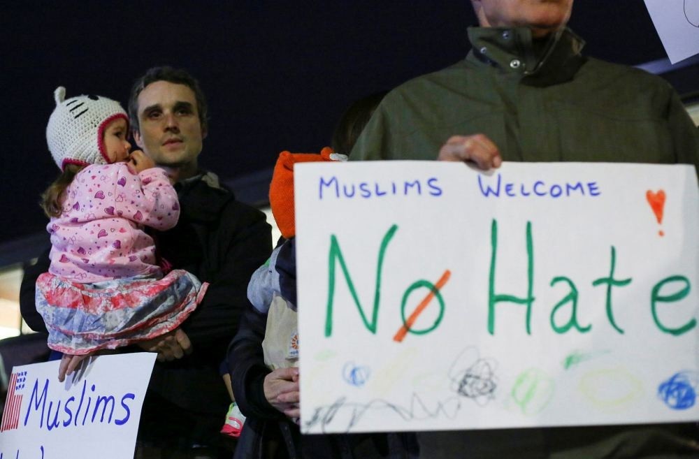 Demonstrators hold signs in support of Muslim residents in downtown Hamtramck, Michigan on Nov. 14.
