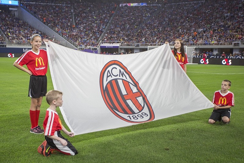 Kids hold up an AC Milan flag ahead of the International Champions Cup soccer match between AC Milan and Chelsea FC on Wednesday, Aug. 3, 2016, in Minneapolis. (AP Photo)