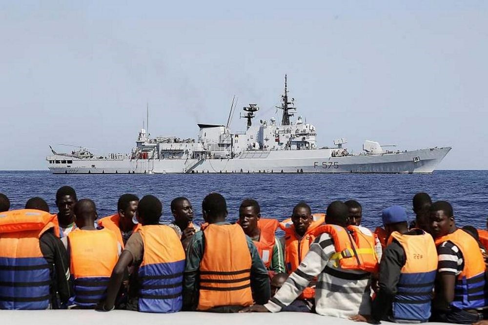Sub-Saharan migrants transported to an Italian Navy vessel during a rescue operation in the southern Mediterranean Sea. (EPA Photo)