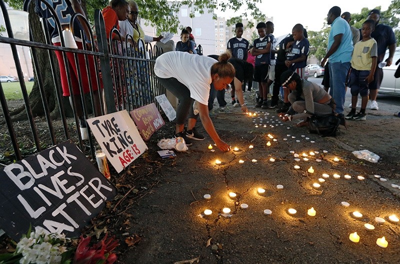 Community members light candles during a vigil for 13-year-old Tyre King Thursday, Sept. 15, 2016, in Columbus, Ohio. King was shot and killed by Columbus police Wednesday evening. (AP Photo)