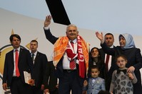 Transport Minister Binali Yu0131ldu0131ru0131m, AK Party sole chairman candidate in emergency convention, and his wife Semiha, wave at party delegates, officials, members and supporters. (AA Photo)