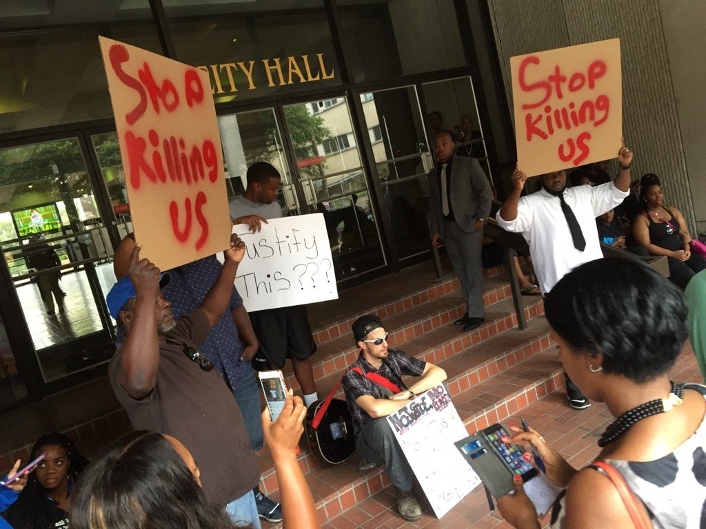 Protesters gather at City Hall in Baton Rouge over the shooting of Alton Sterling Wednesday, July 6, 2016, shortly before a press conference with local leaders. (AP Photo)