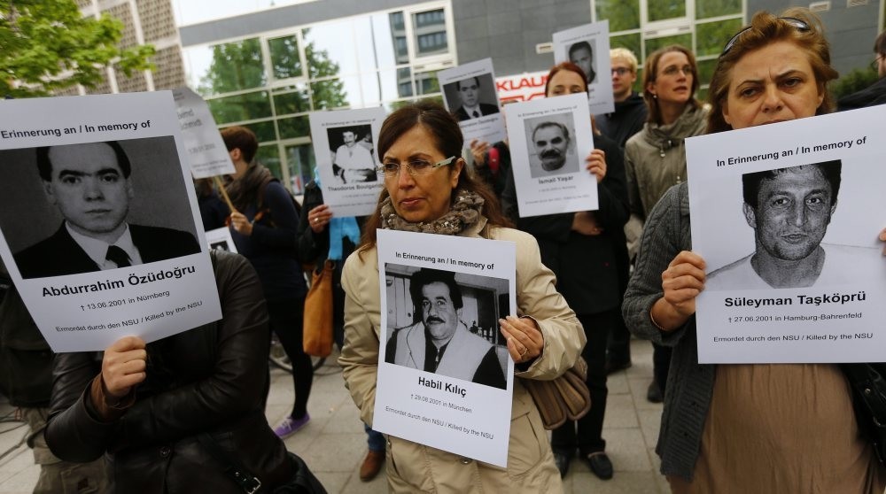 Protesters hold pictures of victims who were killed by the neo-Nazi group National Socialist Underground (NSU).