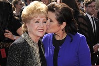 In this Sept. 10, 2011, file photo, Debbie Reynolds, left, and Carrie Fisher arrive at the Primetime Creative Arts Emmy Awards in Los Angeles. (AP Photo)