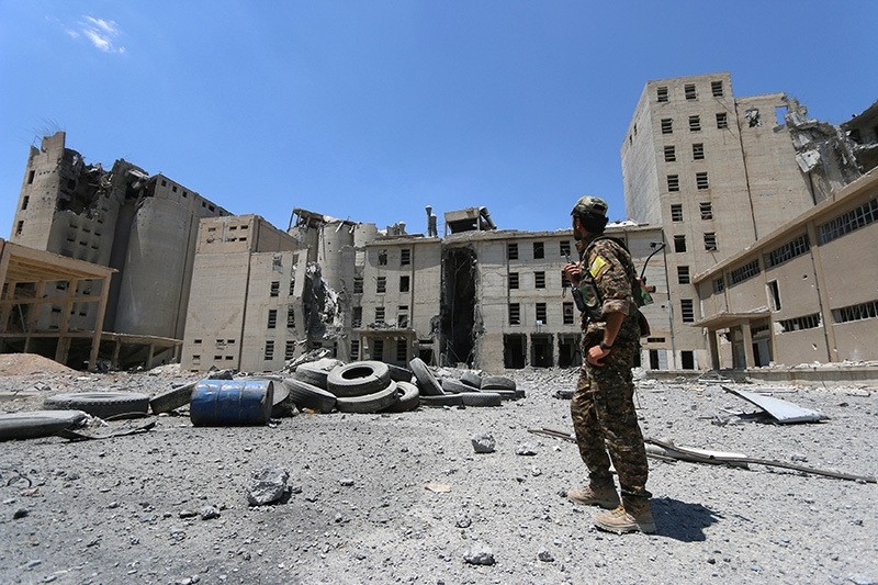 A Syria Democratic Forces (SDF) fighter walks in the silos and mills of Manbij after the SDF took control of it, in Aleppo Governorate, Syria, July 1, 2016. (Reuters Photo)
