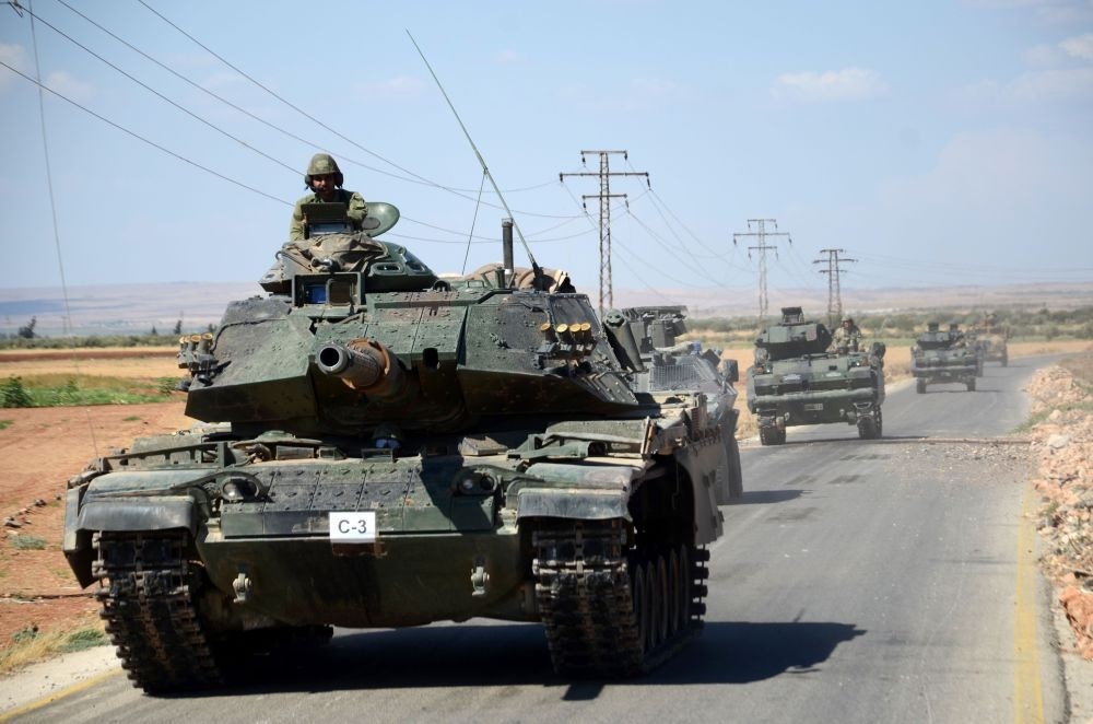 Turkish troops driving their tanks on Sept. 4, 2016 on a road near the Syrian village of al-Waqf and some 3 kilometers south of al-Rai, the small border town with Turkey.