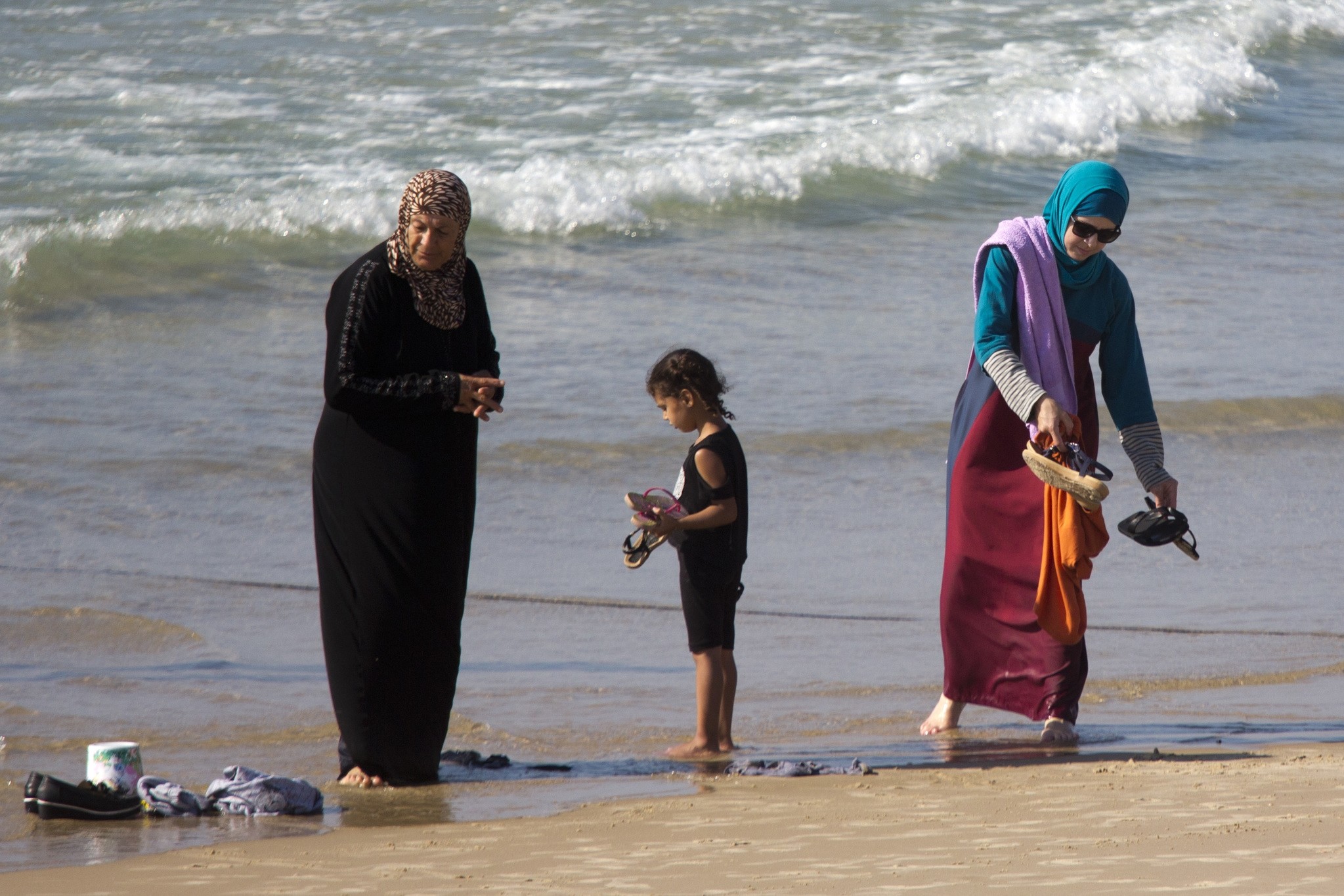 In this Friday, Sept. 2, 2016 photo, Muslim women stand at a beach in Tel Aviv, Israel. (AP Photo)