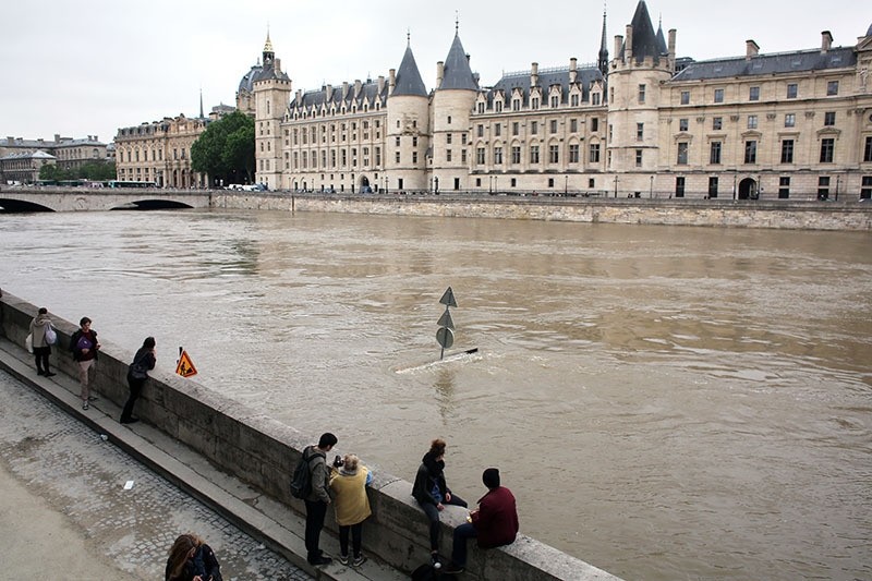 People look at the flooding Seine river, in Paris, Friday June 3, 2016. (AP)