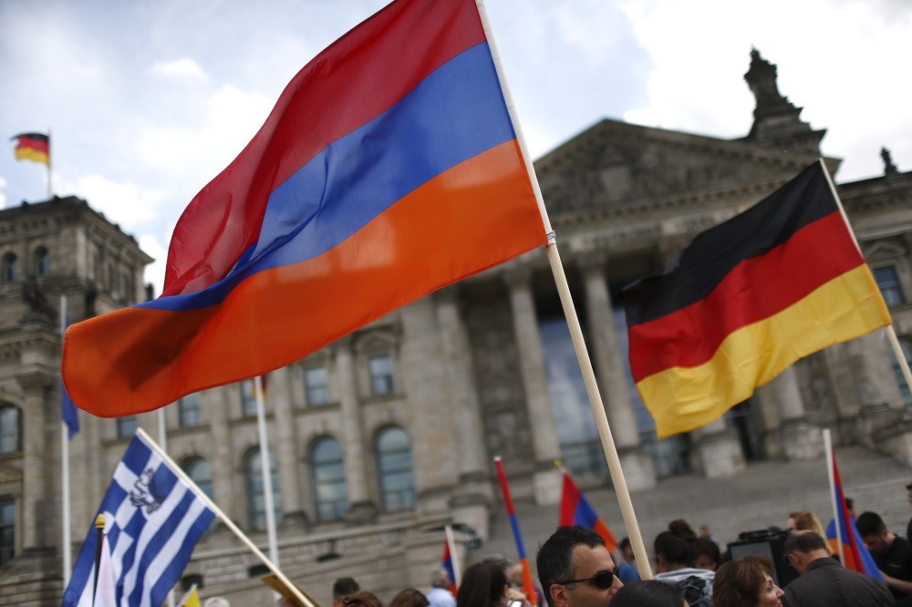 People waving Armenian and German flags in front of the Reichstag in Berlin as they protest in favor of the decision by German parliament that defines the 1915 Armenian incidents as 'genocide'.