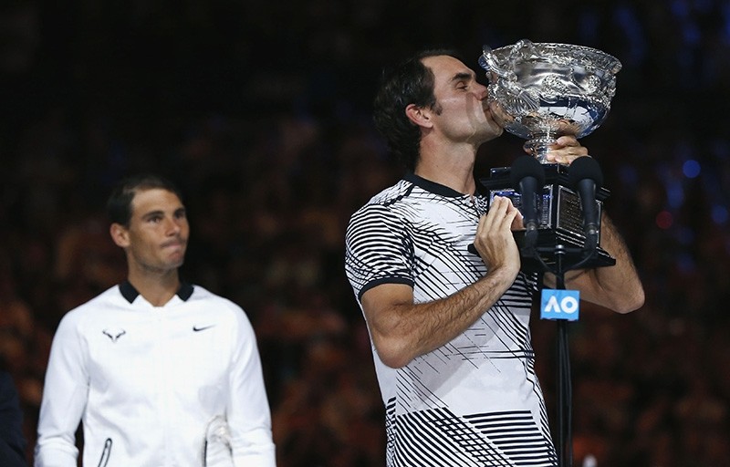 Switzerland's Roger Federer kisses the trophy after winning his Men's singles final match against Spain's Rafael Nadal in Australian Open at the Melbourne Park, Melbourne, Australia. (Reuters Photo)