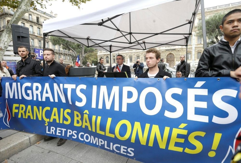 Far-right National Front party holds anti-immigrant demonstration in Marseille, southern France, Nov. 5 as banner reads, ,Migrants imposed, French gagged, Les Republicans party and Socialist Party partners.,