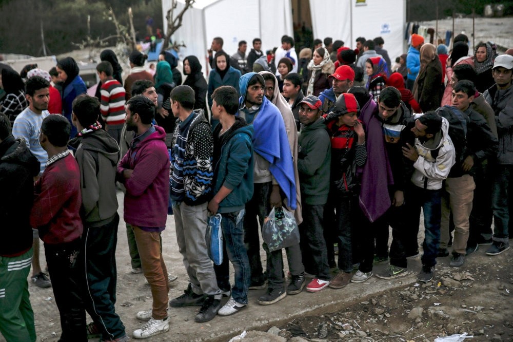 Refugees line up for food distribution at the Moria refugee camp on the Greek island of Lesbos, Nov. 5, 2015.