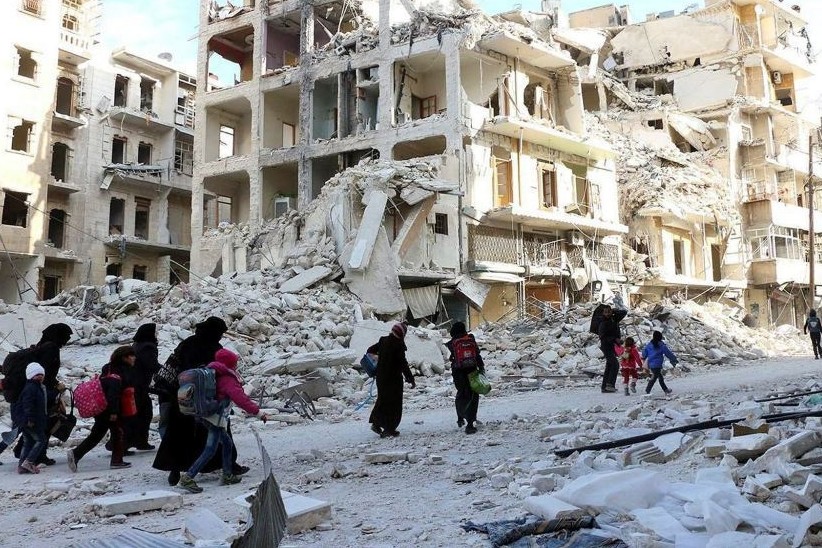 Displaced Syrian families evacuate the neighborhoods where the fighting occured in eastern Aleppo, Syria, Nov. 29.