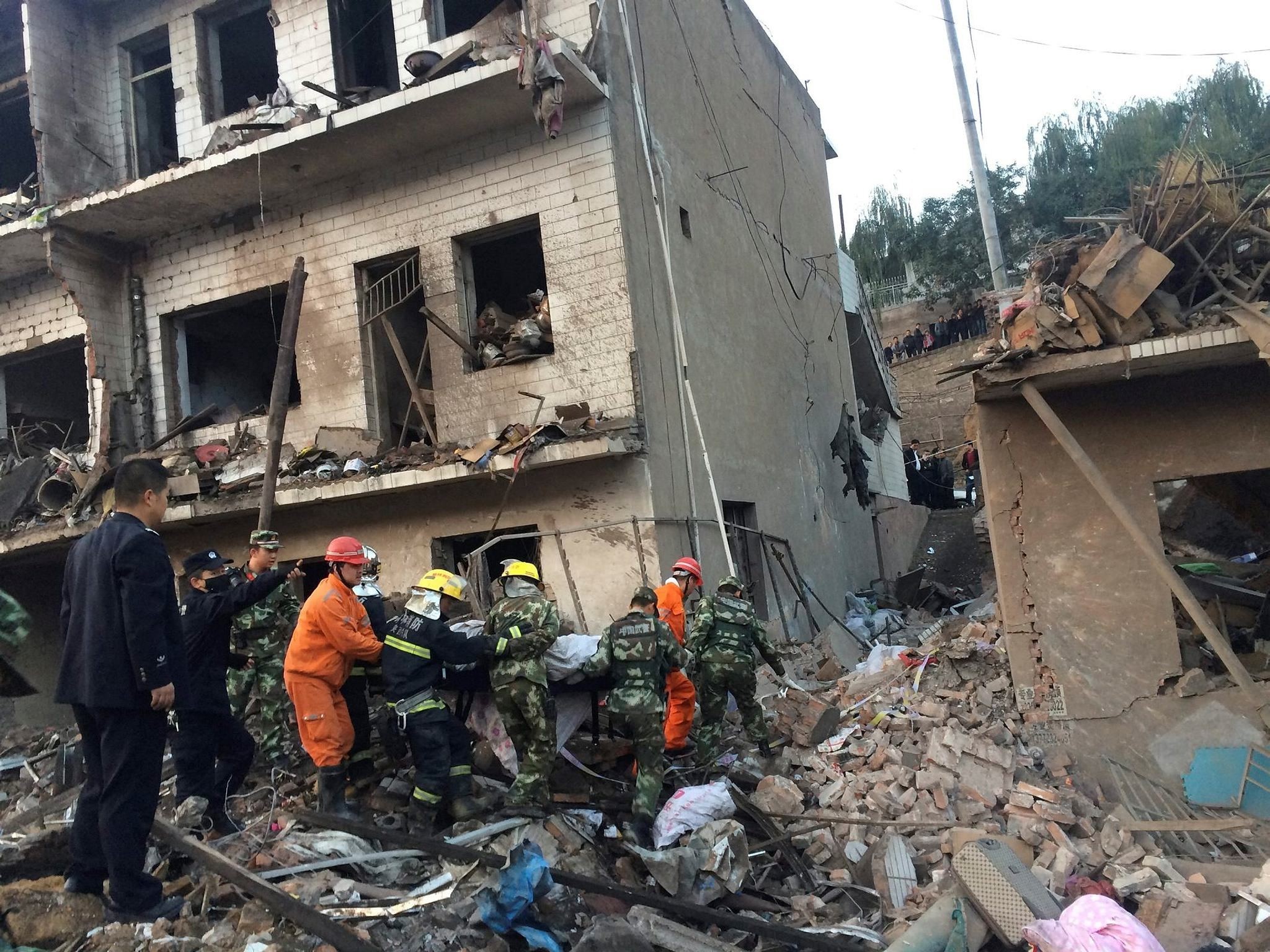 Rescue workers search at site after an explosion hit a town in Fugu county, Shaanxi province, China, October 24, 2016. (China Daily/via REUTERS)