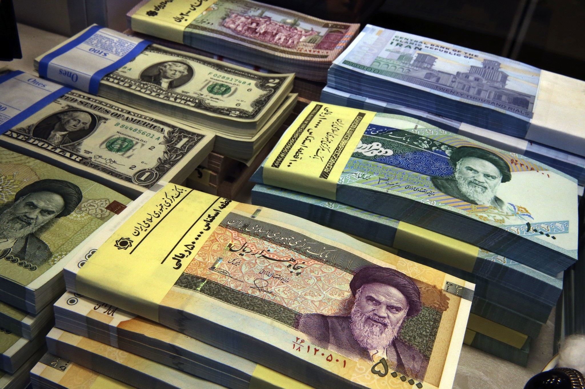 In this April 4, 2015 photo, Iranian and U.S. banknotes are on display at a currency exchange shop in Tehran, Iran. (AP Photo)