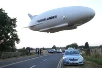 his file photo taken on August 17, 2016 shows the Hybrid Air Vehicles HAV 304 Airlander 10 hybrid airship in the air over a road on its maiden flight from Cardington Airfield. (AFP Photo) 