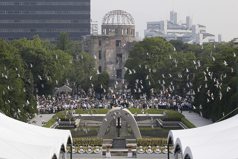 Doves fly up past a cenotaph and the Atomic Bomb Dome during the peace memorial ceremony marking the 71st anniversary of the nuclear bombing of the city at Hiroshima Peace Memorial Park in Hiroshima, western Japan, 06 August 2016. (EPA Photo)