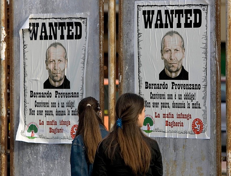 This file photo taken on April 28, 2005 in Bagheria shows women looking at posters bearing pictures of ,Cosa Nostra, mafia boss Bernardo Provenzano. (AFP Photo) 