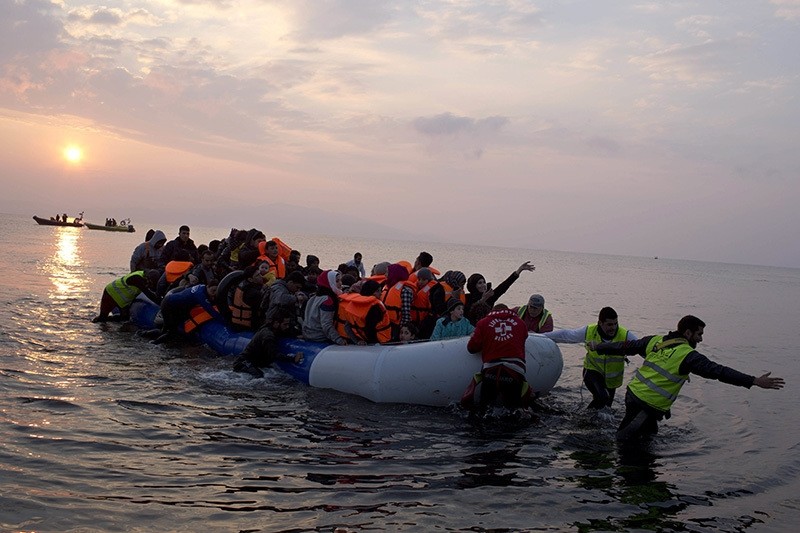 Refugees on a dingy as they arrive at the shore of the northeastern Greek island of Lesbos, after crossing the Aegean sea from Turkey, March 20, 2016. (AP Photo)