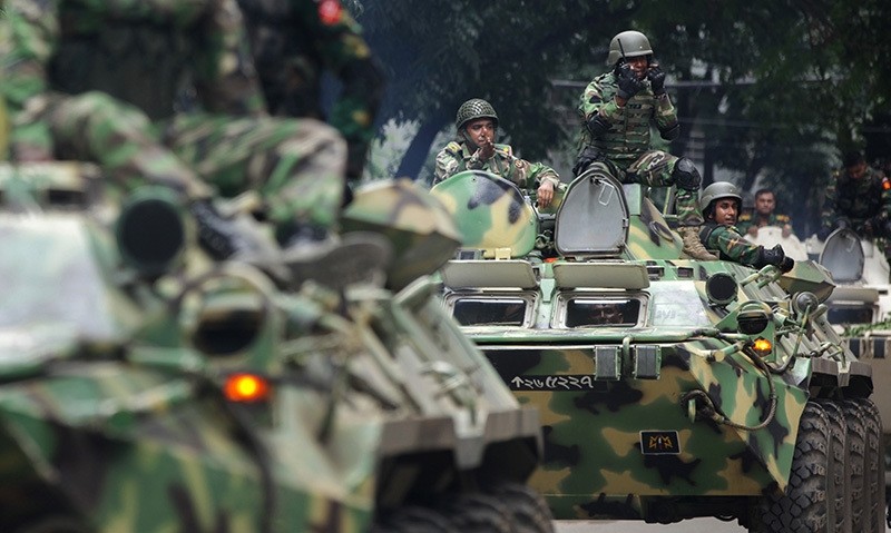 Armored vehicles arrive after militants took hostages at a restaurant popular with foreigners in Dhaka, Bangladesh, Saturday, July 2, 2016 (AP Photo)