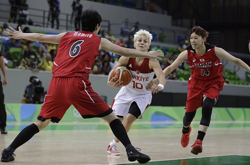 Turkey guard Iu015fu0131l Alben (10) drives to the basket between Japan center Yuka Mamiya (6) and guard Sanae Motokawa during the second half of a women's basketball game at the Youth Center in Rio de Janeiro, Brazil, Tuesday, Aug. 9, 2016. (AP Photo)