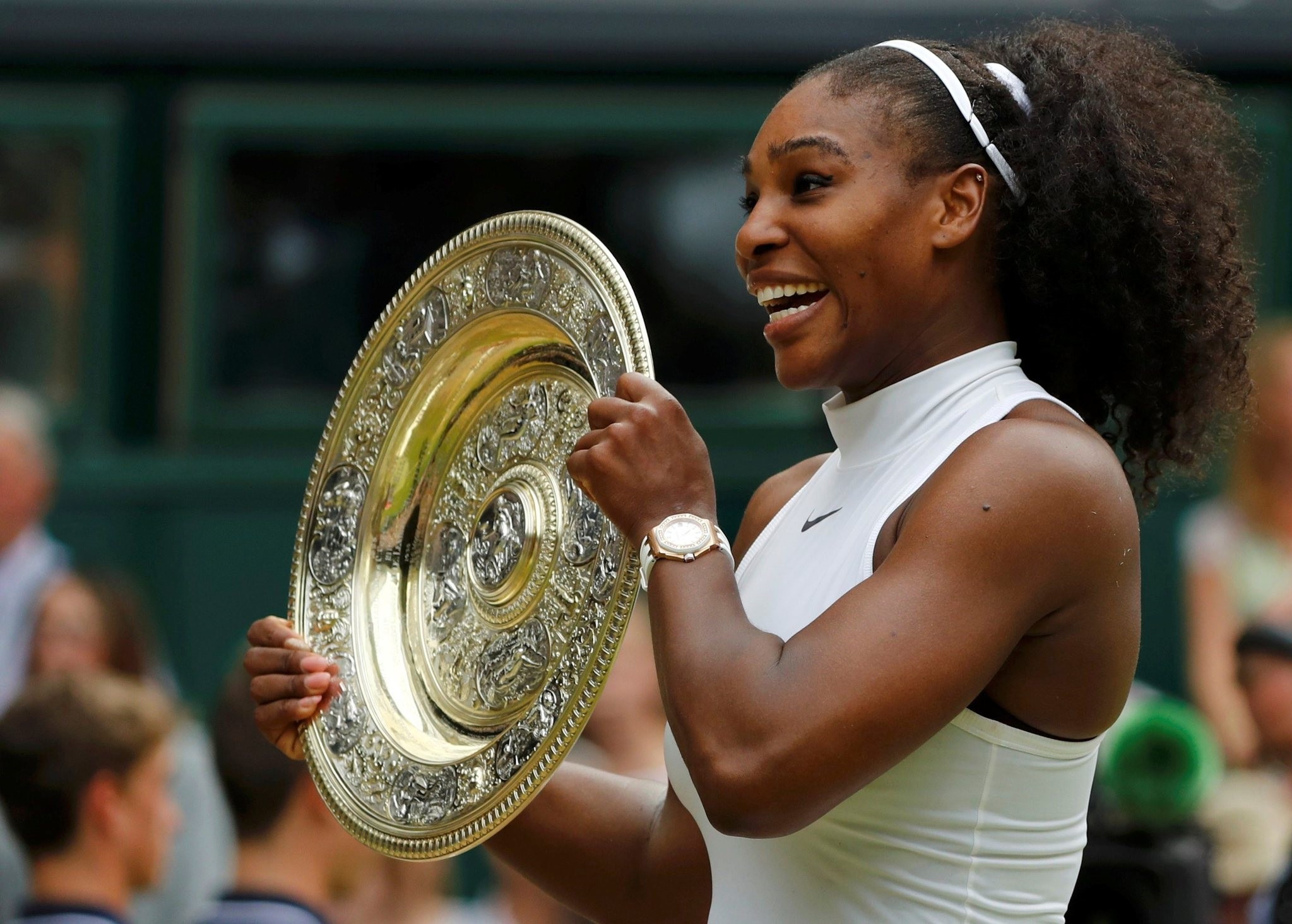 Serena Williams celebrates winning her Womenu2019s singles final match against Germany's Angelique Kerber with the trophy, Wimbledon, Britain. (Reuters Photo)
