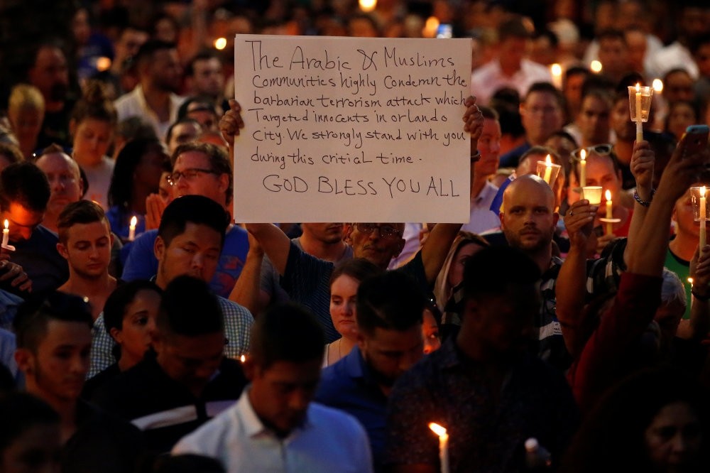 People take part in a candlelight memorial service day after the mass shooting at a nightclub in Orlando, Florida, June 13.