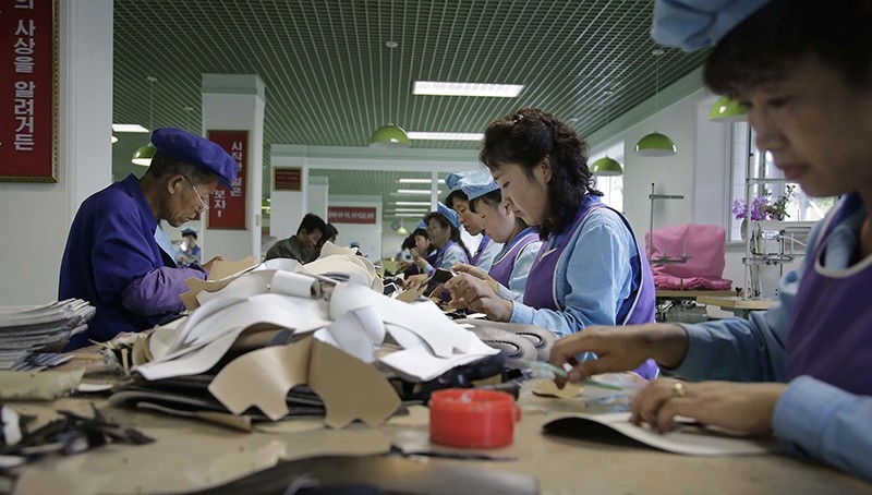 In this Wednesday, June 22, 2016, photo, factory workers tend to their stations at a shoe factory in Wonsan, North Korea (AP Photo)
