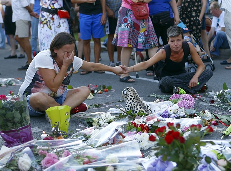 People pay tribute to the victims at the site of a deadly truck attack on the famed Promenade des Anglais in Nice, southern France, Saturday, July 16, 2016. (AP Photo)