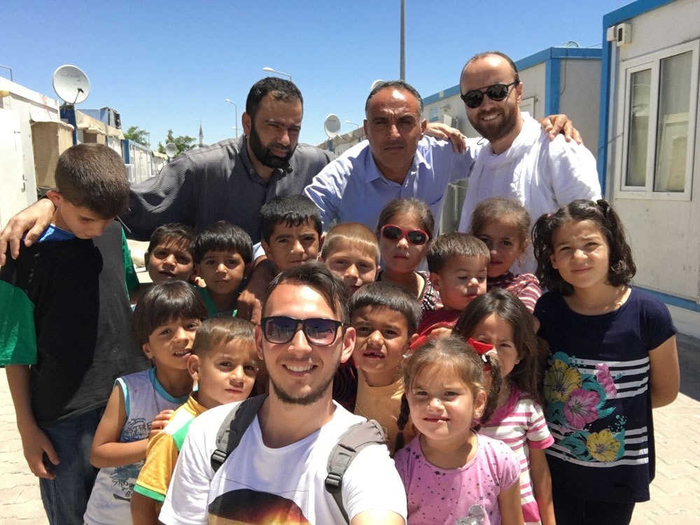 Daily Sabahu2019s Yunus Paksoy with Syrian children at the Harran refugee camp.