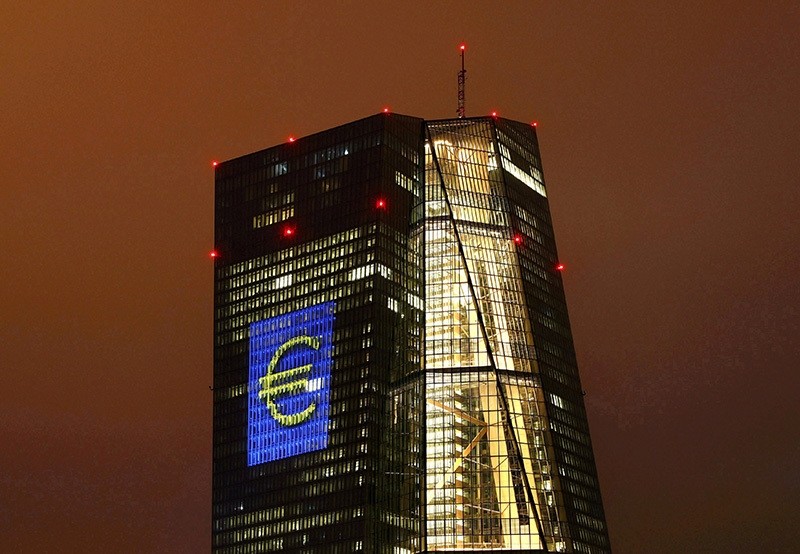 The headquarters of the European Central Bank (ECB) are illuminated with a giant euro sign at the start of the ,Luminale, light and building, event in Frankfurt, Germany, March 12, 2016. (Reuters Photo)