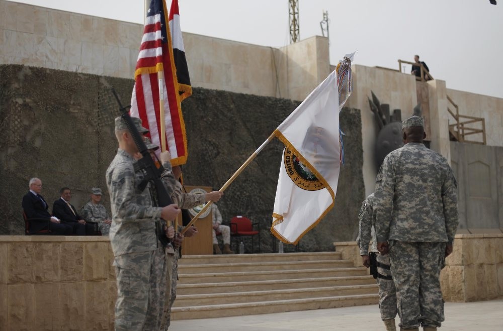 U.S. Secretary of Defense Leon Panetta, second from the left, and Ambassador to Iraq James Jeffrey, far left, at the U.S. Forces-Iraq colors casing ceremony, Baghdad, Iraq, Dec. 15, 2011.