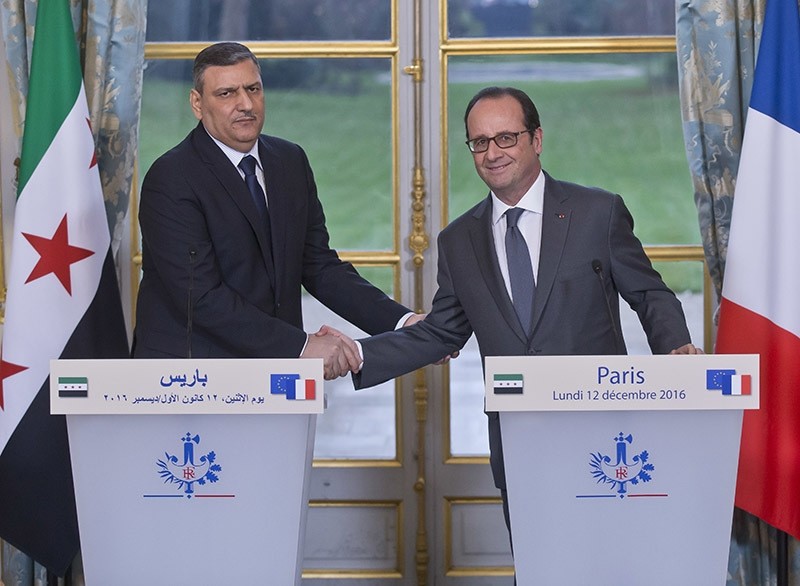 Chief Negotiator for the Syrian Opposition Riyad Hijab, left, and French President Francois Hollande shake hands during a joint media conference at the Elysu00e9e Palace in Paris on Dec. 12, 2016. (AP Photo)