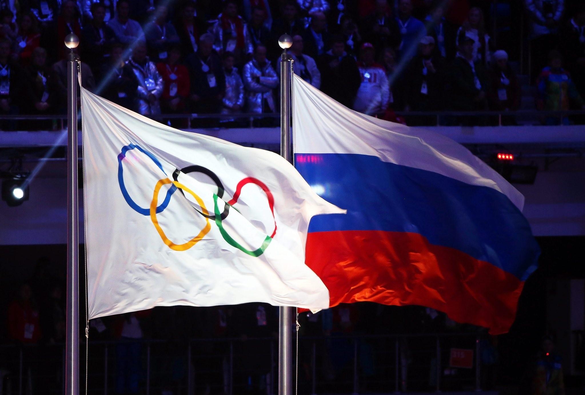 A file picture dated 23 February 2014 of the Olympic flag (L) and the Russian flag (R) during the Closing Ceremony of the Sochi 2014 Olympic Games in the Fisht Olympic Stadium in Sochi, Russia. (EPA Photo)