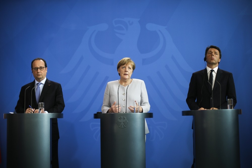 France's President Franu00e7ois Hollande, (L), German Chancellor Angela Merkel, (C) and the Prime Minister of Italy Matteo Renzi, (R), brief the media during a meeting at the chancellery in Berlin on June 27. 
