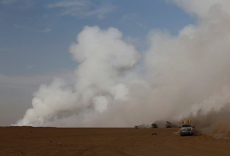 Smoke rises from a sulfur factory after Daesh terrorists set fire to it releasing toxic smoke over the area at south of Mosul, Iraq, October 21, 2016. (Reuters Photo)
