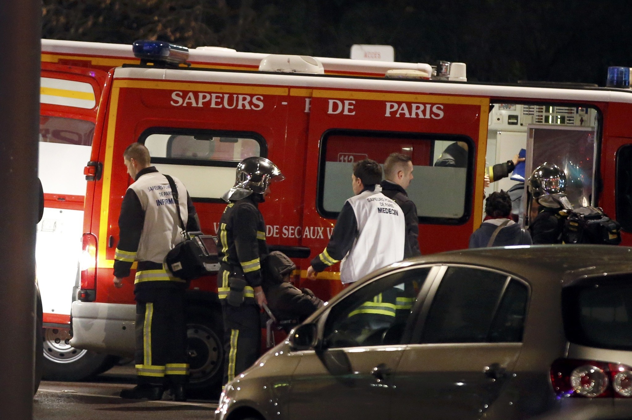 French firemen and doctors tend to a person who was one of six people in a travel agency when an armed man entered in what appears to be a robbery. (REUTERS Photo)