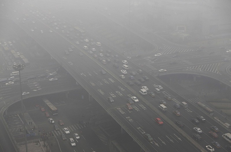 Vehicles drive through the Guomao Bridge on a heavy haze day in Beijing's central business district. (Reuters Archive Photo)