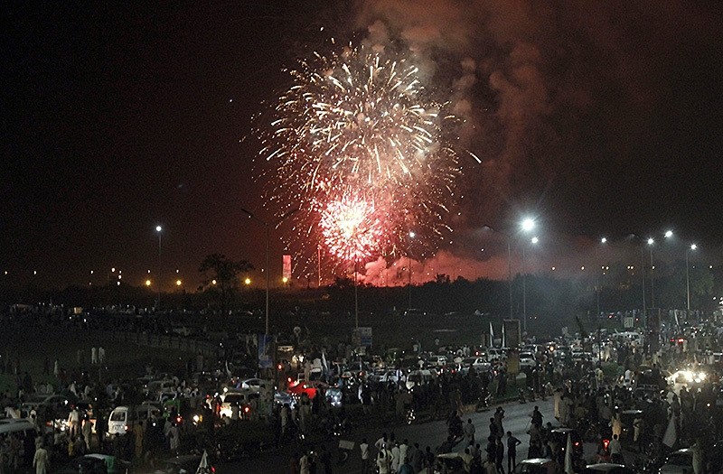 Pakistan people gather to watch a firework display during Pakistan Independence Day celebrations in Islamabad, Pakistan, Sunday, Aug. 14, 2106. (AP Photo)