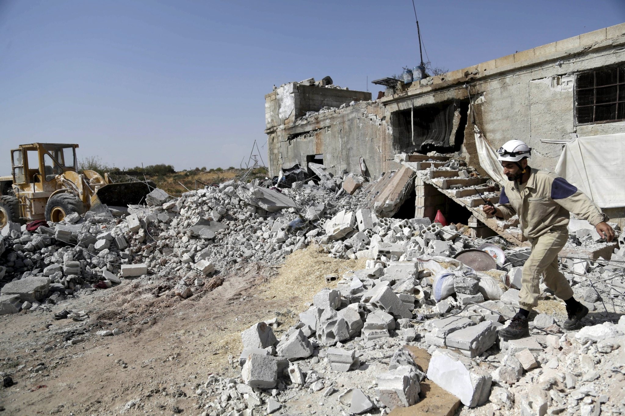 A civil defence member walks on the rubble of a damaged building next to a site hit by what activists said were airstrikes carried out by the Russian air force. (Reuters Photo)