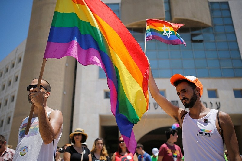 Revelers observe a minute's silence in memory of the victims of the Pulse gay nightclub shooting in Orlando, Florida, during a gay pride parade in the southern city of Ashdod, Israel, June 17, 2016. (Reuters Photo)