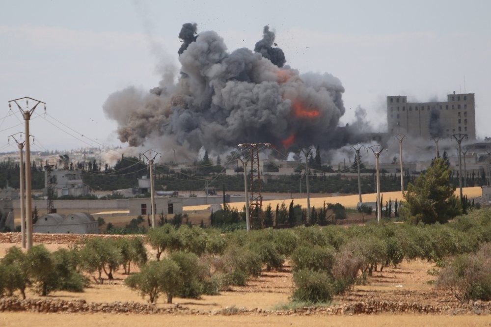 Smoke and flames rise after what SDF fighters said were U.S.-led airstrikes on mills in Manbij where DAESH militants are positioned in Aleppo Governorate, Syria, June 16.