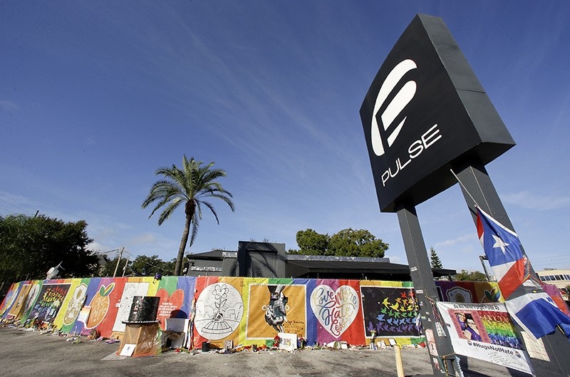 Artwork and signatures cover a fence around the Pulse nightclub, scene of a mass shooting by Daesh, Orlando, Nov. 30, 2016. (AP Photo)