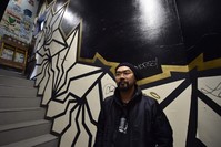  Japanese street artist Kohei Yamao, better known by his nom d'artiste BAKIBAKI, poses with his work in Tokyo. 
