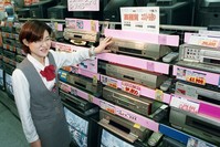 In this Oct. 31, 1998 photo, a salesclerk shows high quality VHS video casette recorders at a home and electrical appliance store in Osaka.