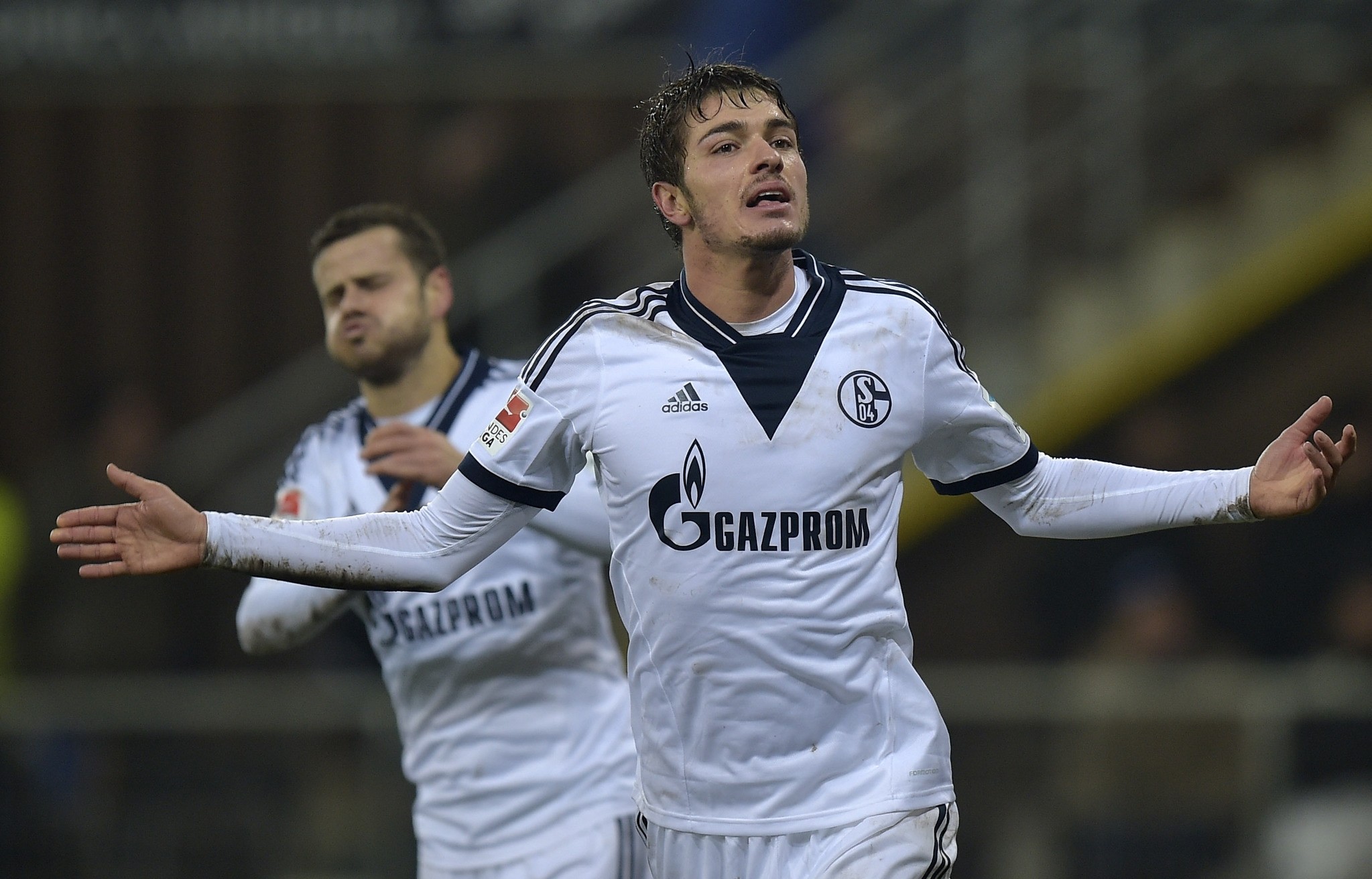 Schalke's Roman Neustaedter celebrates his decisive goal in front of Schalke's Tranquillo Barnetta from Switzerland, left, during the German Bundesliga soccer match. (AP Photo) 