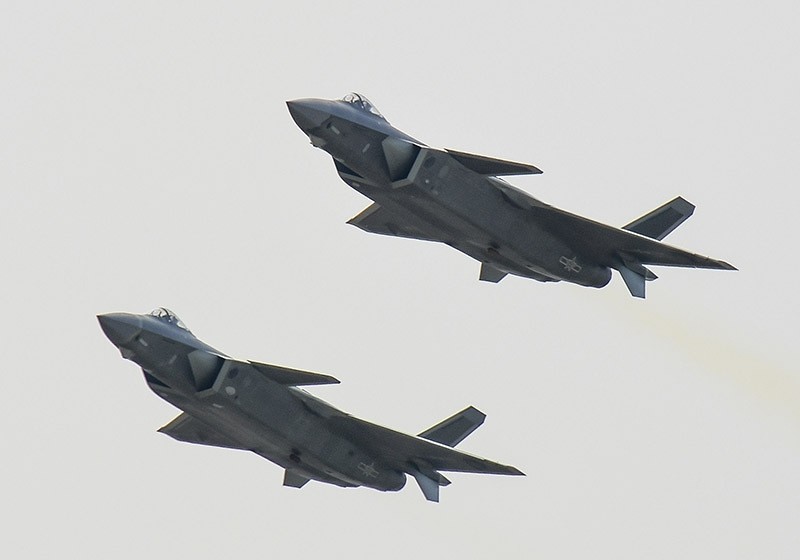 A pair of J-20 stealth fighter jets fly at the China's International Aviation and Aerospace Exhibition in Zhuhai, China's Guangdong province, Tuesday, Nov. 1, 2016. (AP Photo)